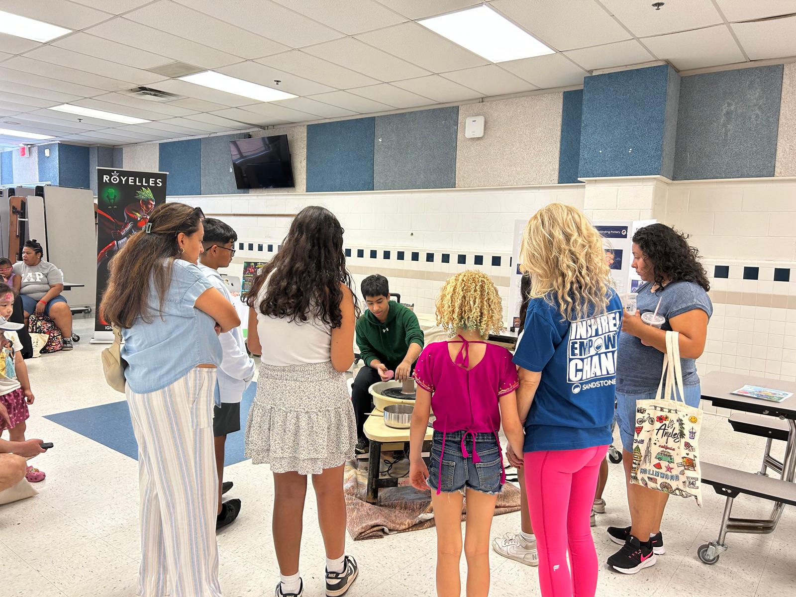 A pottery wheel station at a school district summer event